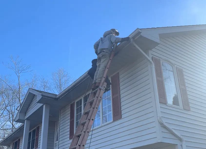 Gutter cleaning and maintenance being performed by Stow Power Washing in Stow